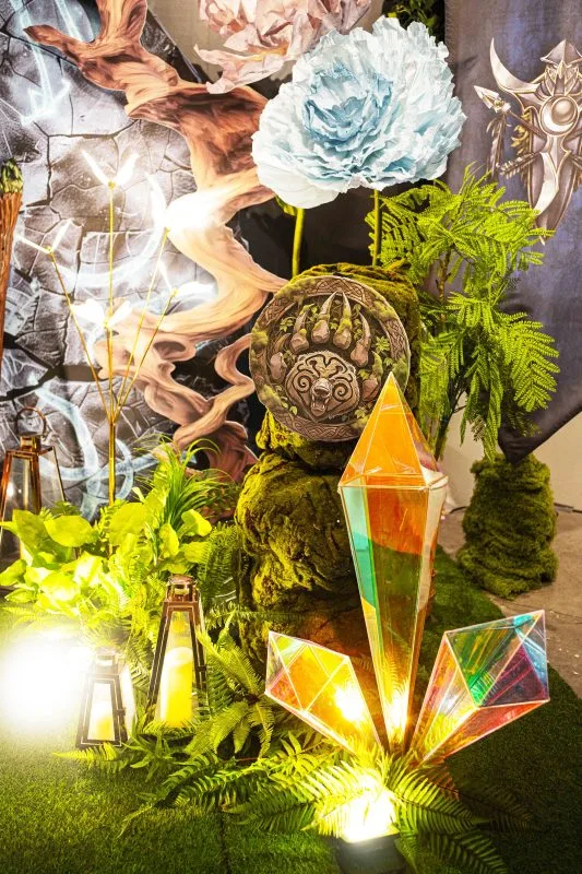 奇幻主題婚禮佈景,翠綠植栽、柔和燈籠光,搭配璀璨晶石與藍色大花。